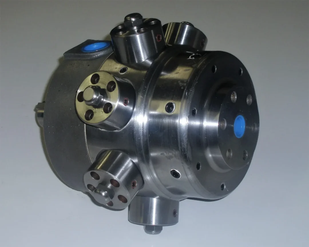Metal hydraulic component featuring multiple ports and a blue circular detail, designed for fluid control in machinery